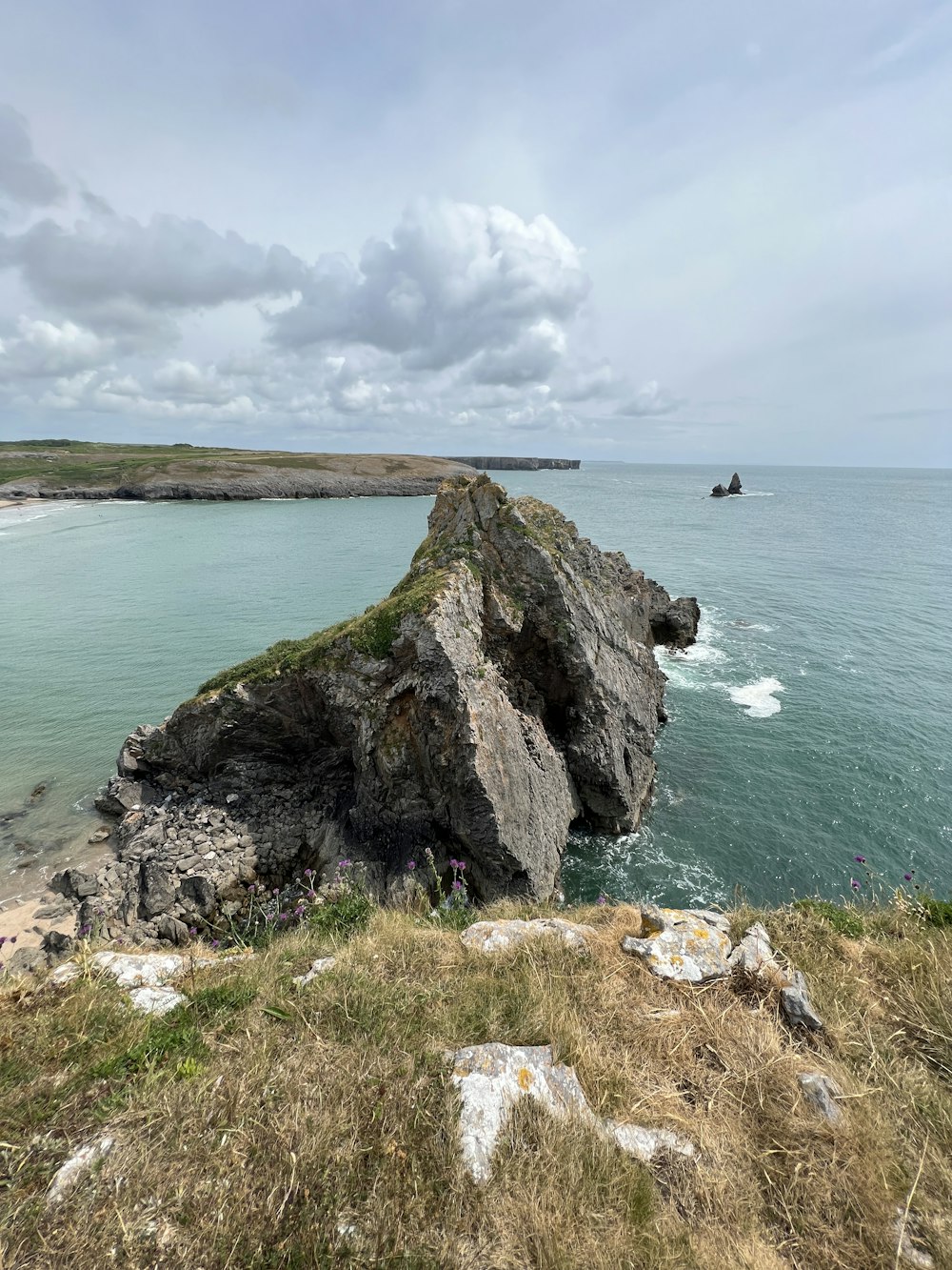 a large rock sticking out of the ocean