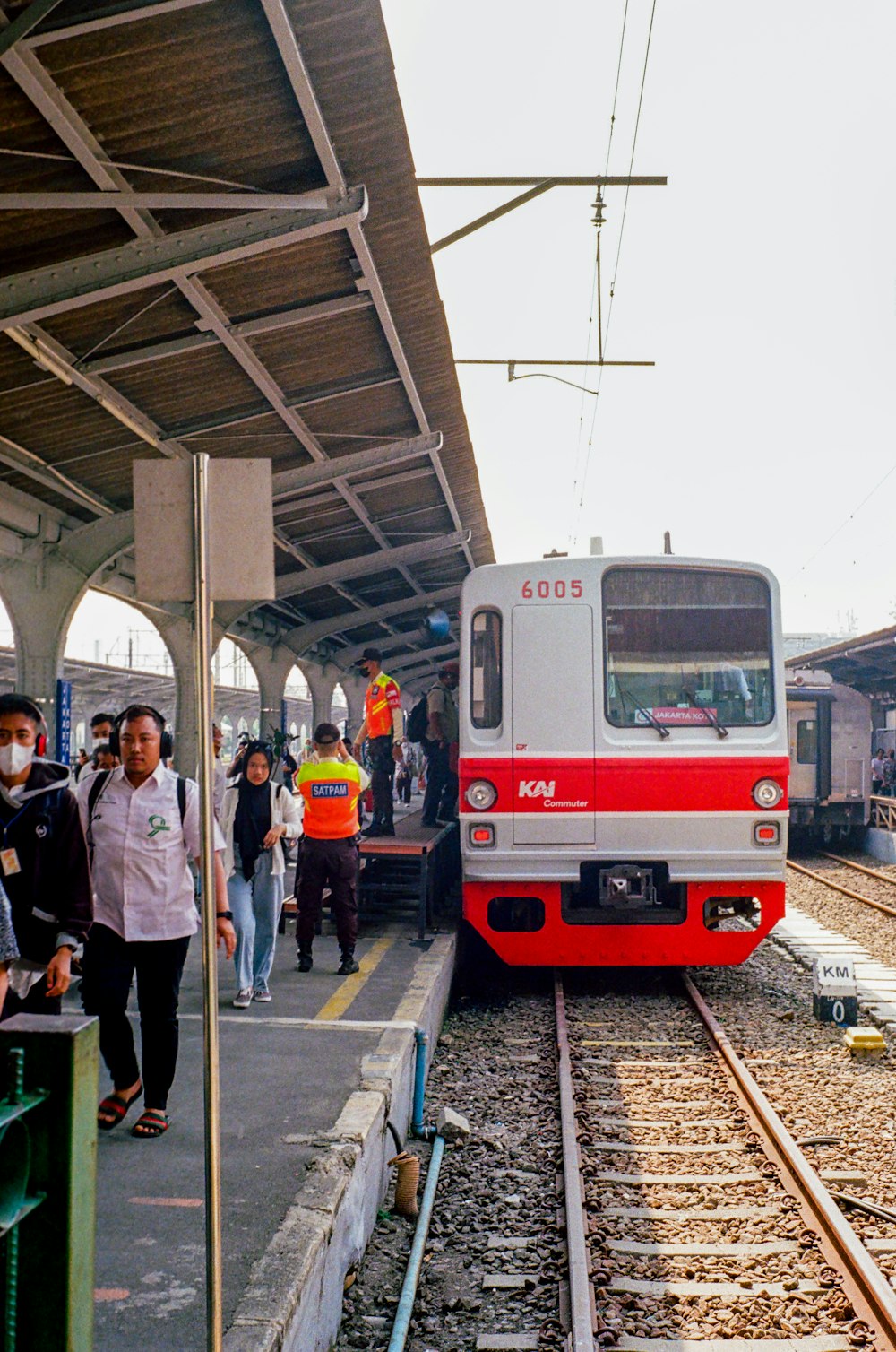 a red and white train pulling into a train station