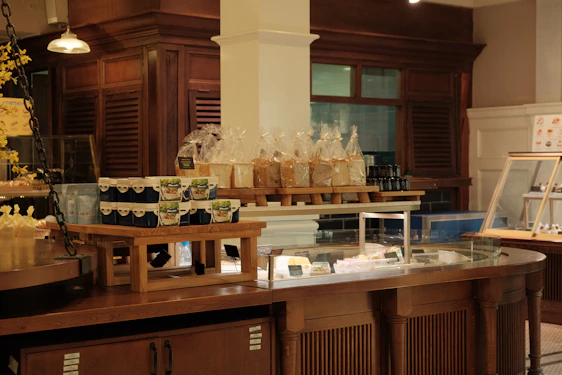 Warm interior of a rustic mountain bakery with fresh bread and pastries on wooden shelves.