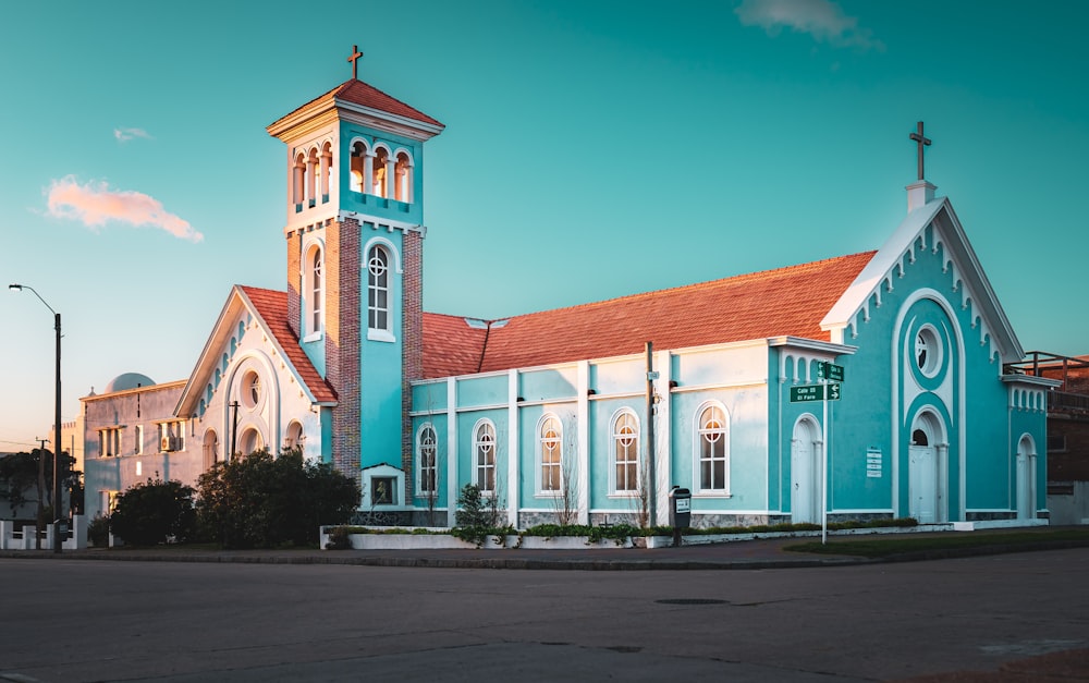 a large blue church with a red roof
