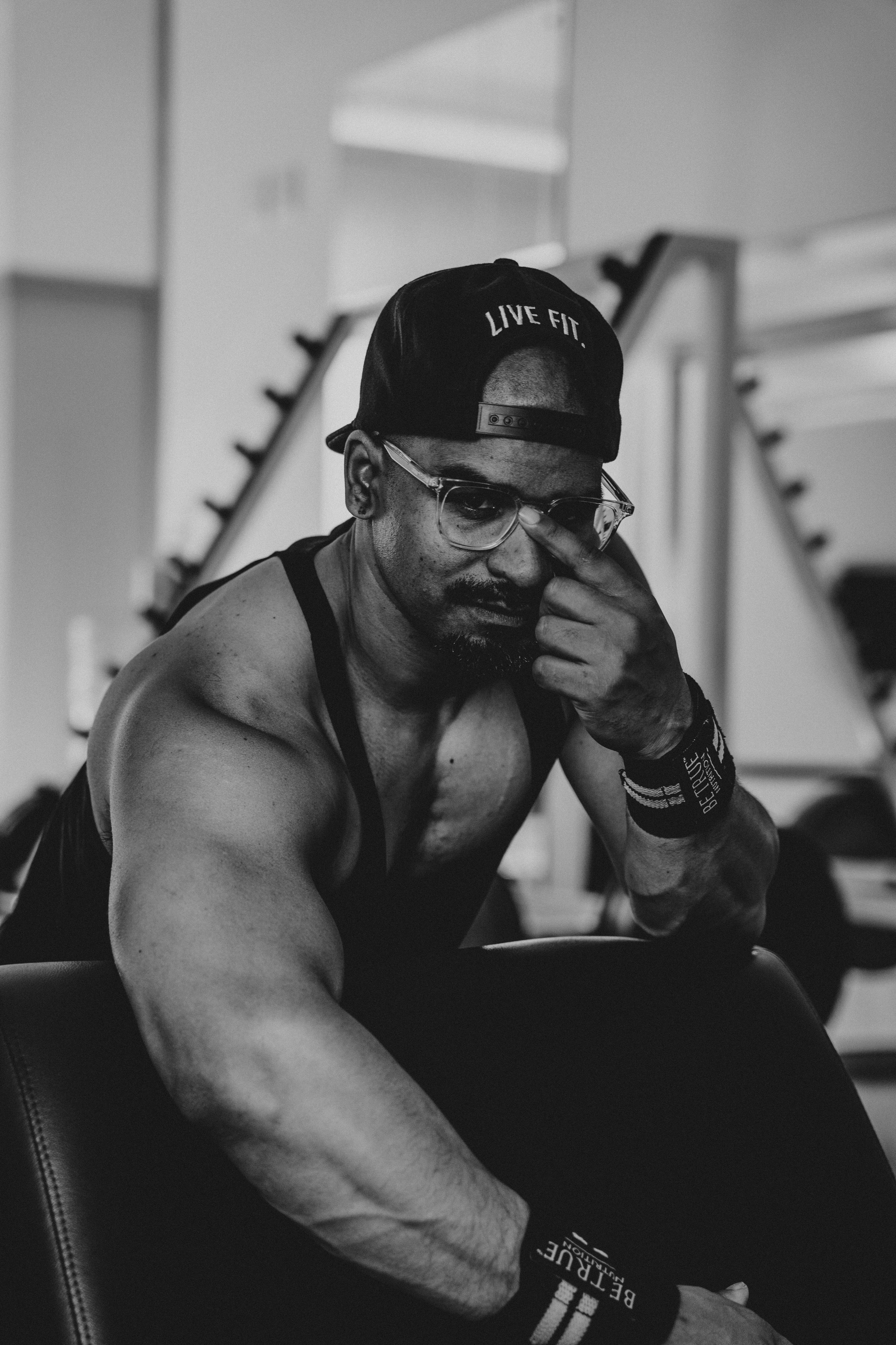 a man sitting on a chair in a gym