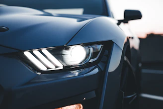 Close-up of sleek LED headlights installed on a modern car at dusk