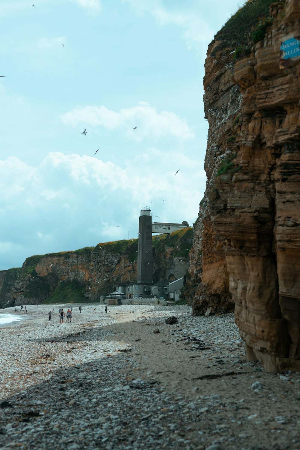 a group of people standing on top of a sandy beach