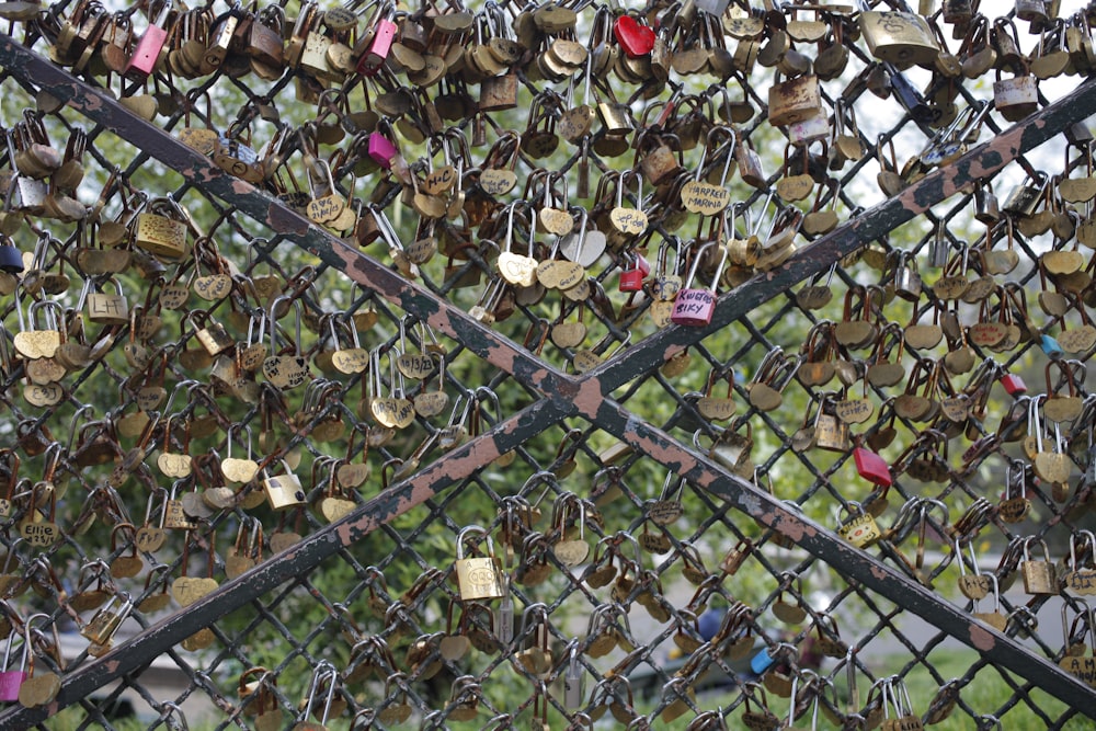 many padlocks are attached to a fence