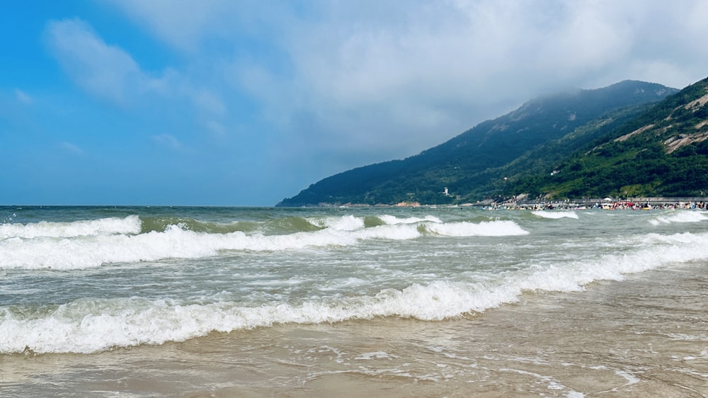 a body of water with a mountain in the background