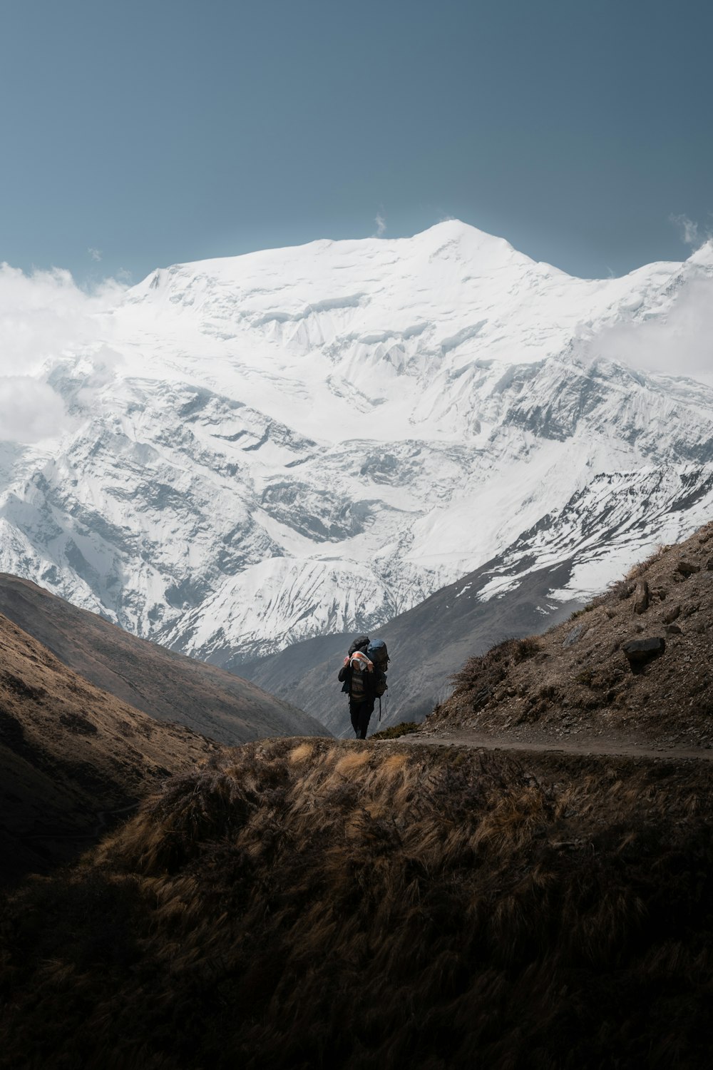 a man with a backpack walking up a hill