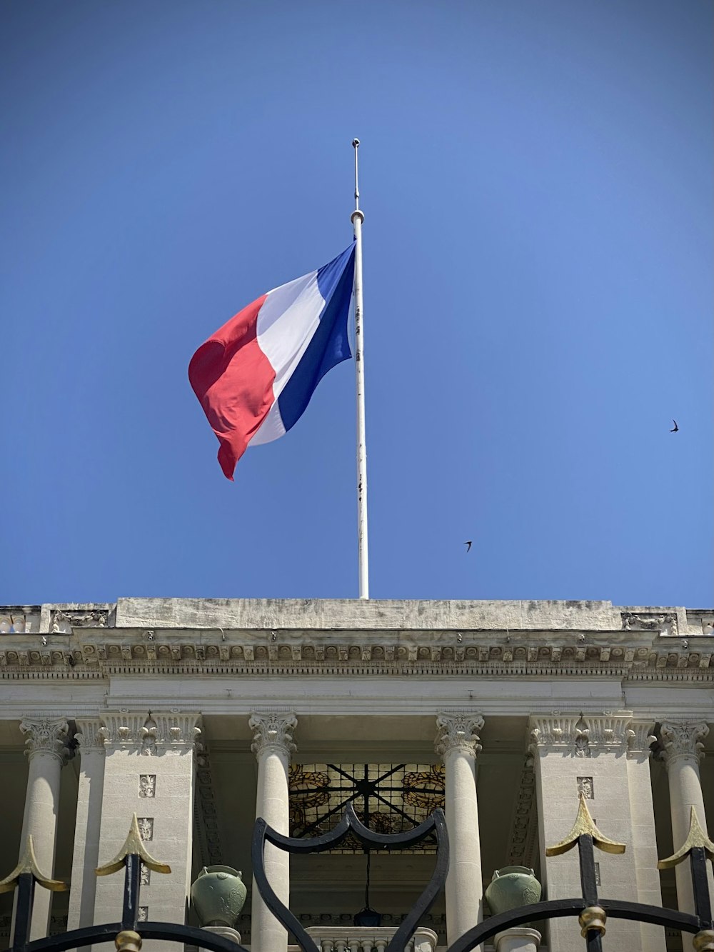 a flag is flying in front of a building