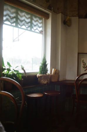 A cozy café corner with a wooden table, a cup of coffee, and soft natural light streaming through the window.