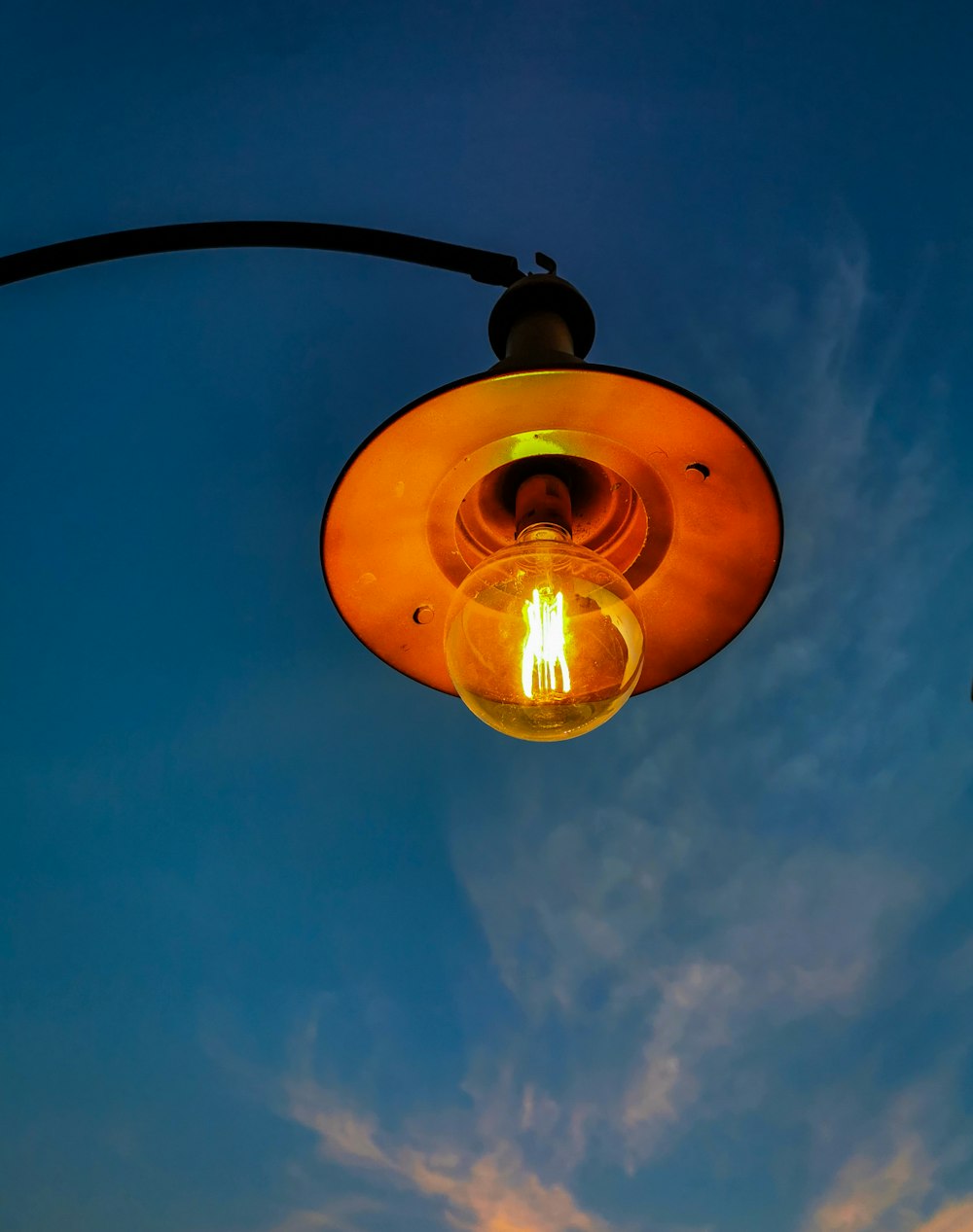 a street light with a blue sky in the background