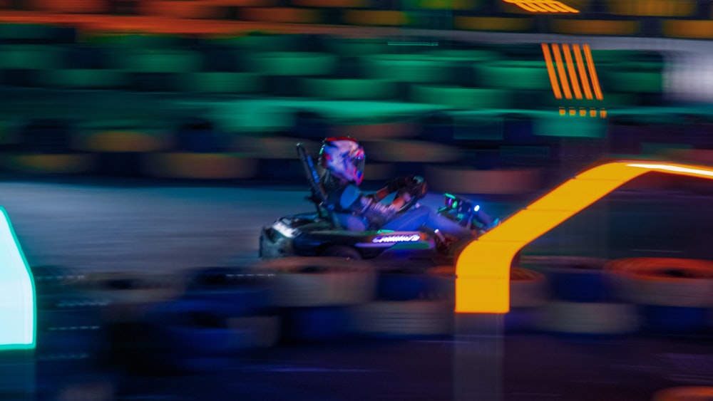 a blurry photo of a person in a go kart
