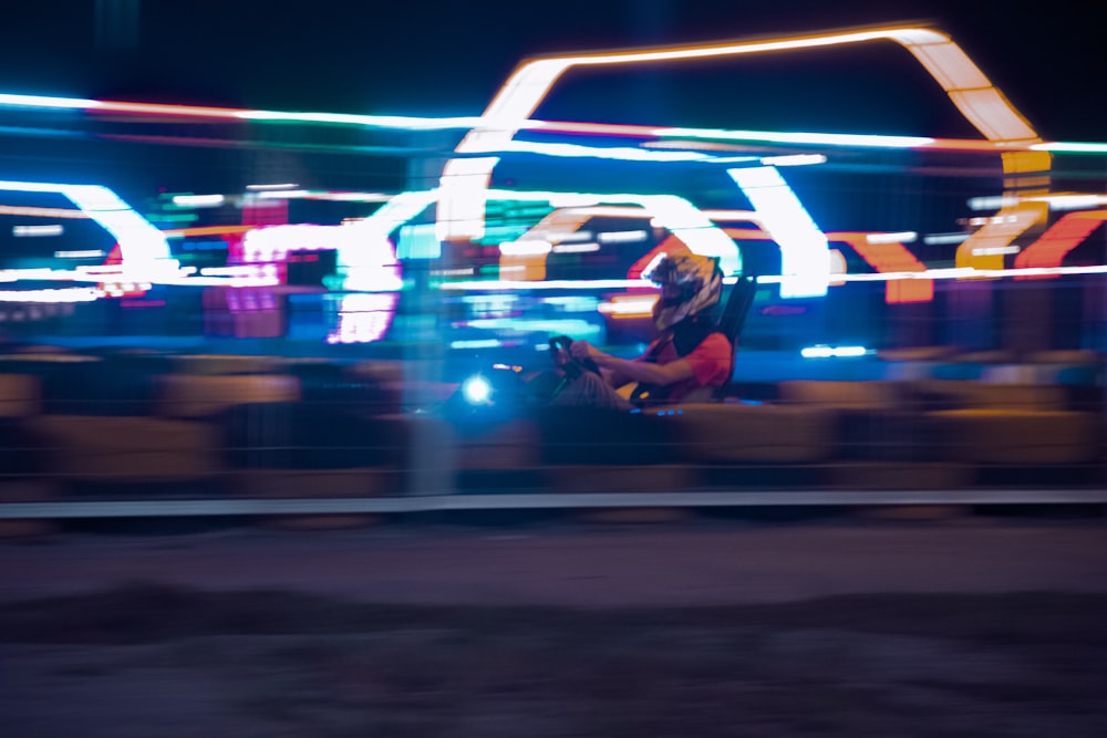 a blurry photo of a carnival ride at night