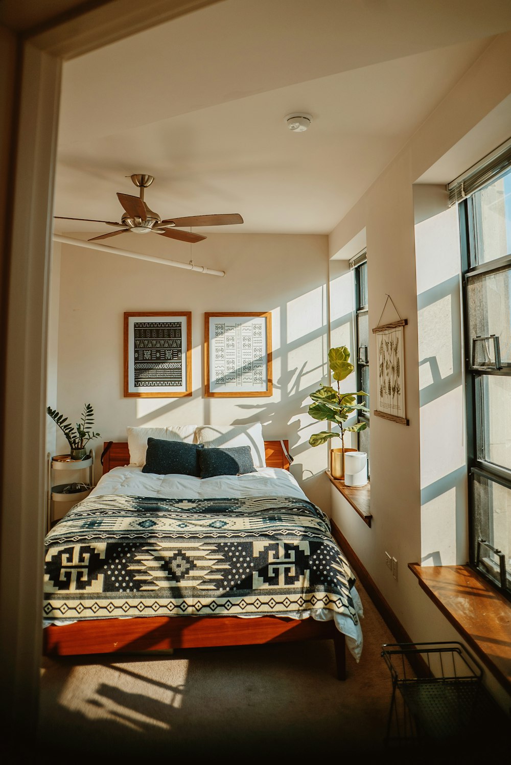 a bedroom with a bed and a ceiling fan