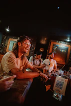 Friendly staff serving drinks and smiling at customers in a lively atmosphere