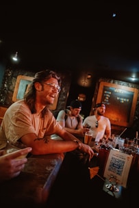 a group of men sitting at a bar