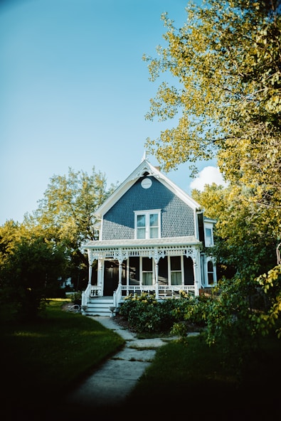 a blue and white house with a porch