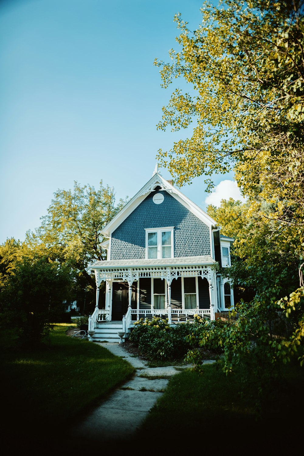 a blue and white house with a porch