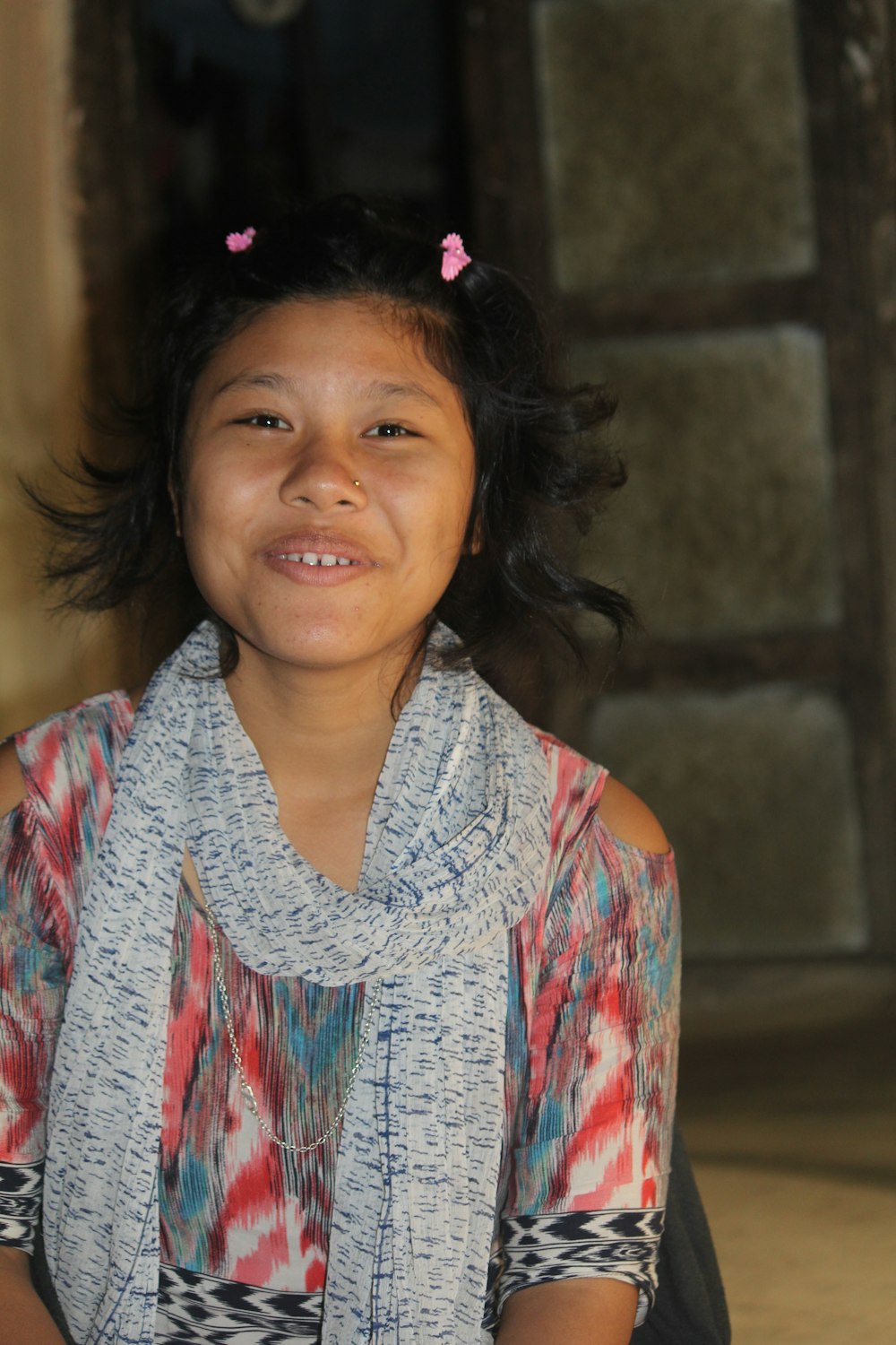 a young girl with a scarf around her neck