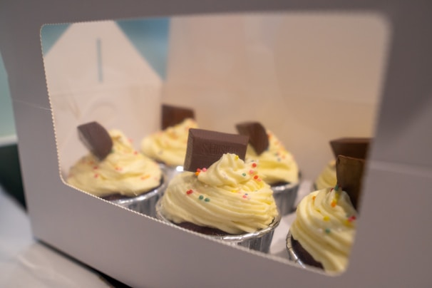 Close-up of colorful assorted cupcakes with creamy frosting