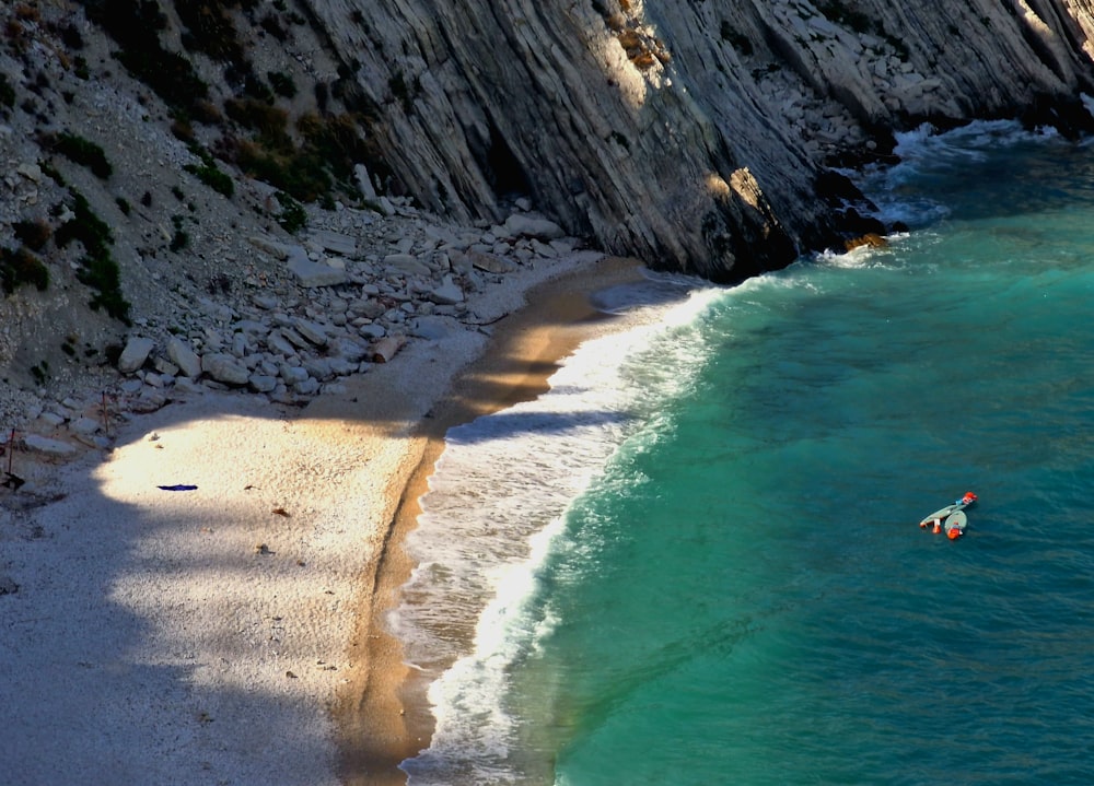 a man riding a surfboard on top of a body of water