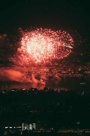 A dramatic VFX scene showing a cityscape with fiery explosions and flying debris.