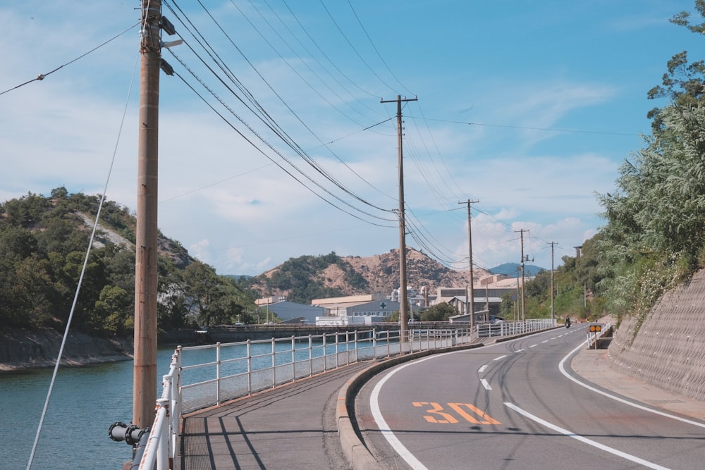 an empty road with power lines above it