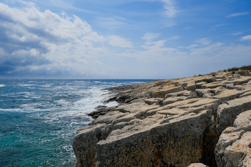 a view of the ocean from a rocky cliff