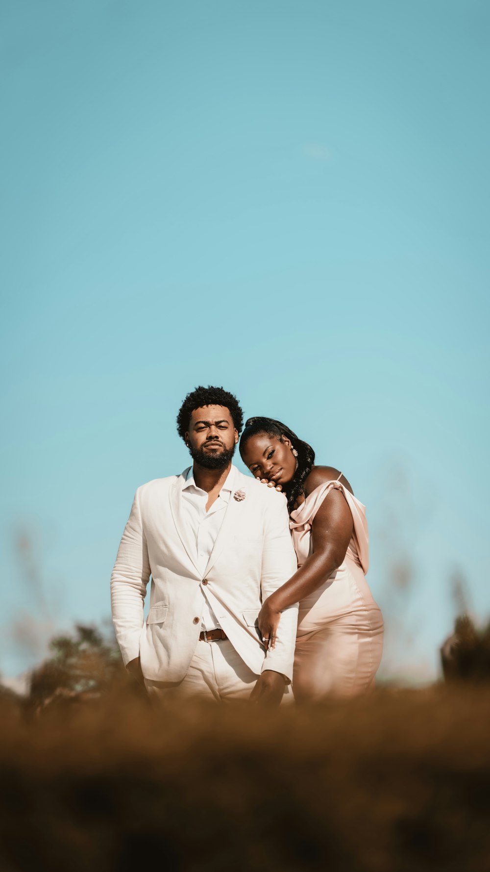 a man and a woman standing in a field