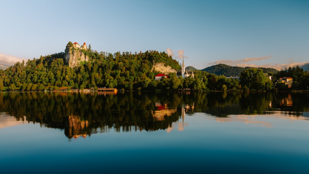 a castle sits on a small island in the middle of a lake