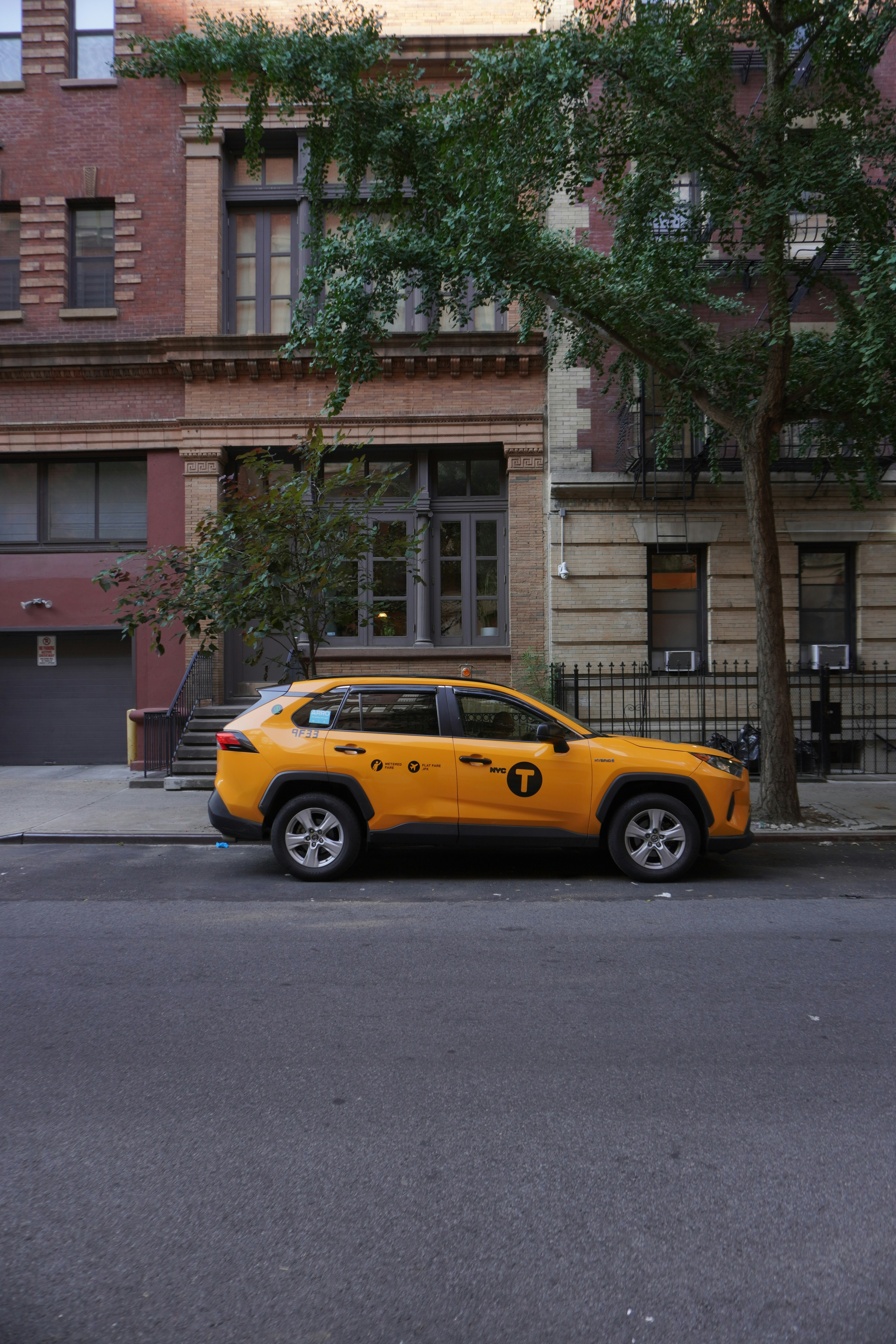 a yellow car parked on the side of the road