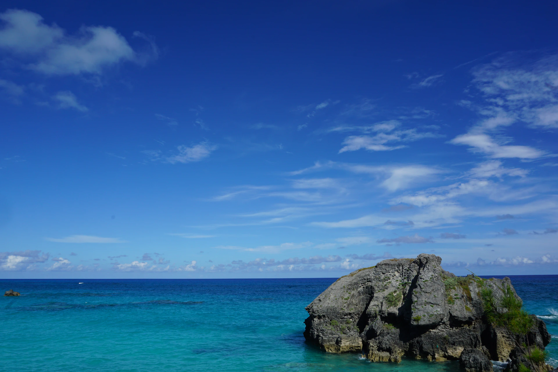 a large rock in the middle of the ocean