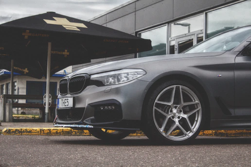 A sleek, modern vehicle parked outside a community center in New Mexico.
