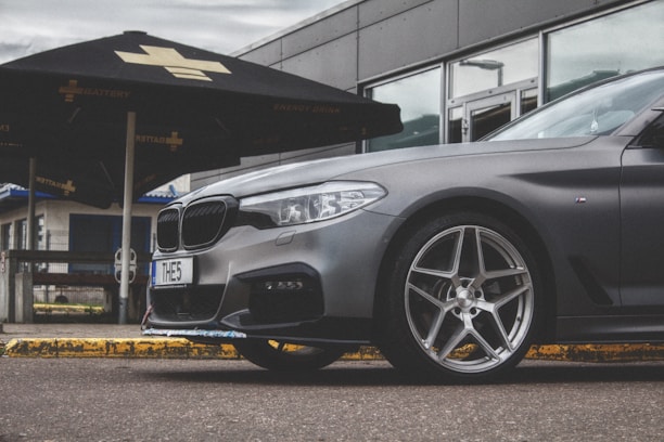 A sleek car parked outside with Lease Opti branding visible in the background.