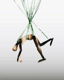 a woman in a tight bodysuit is suspended in the air