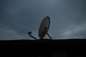 a satellite dish sitting on top of a roof