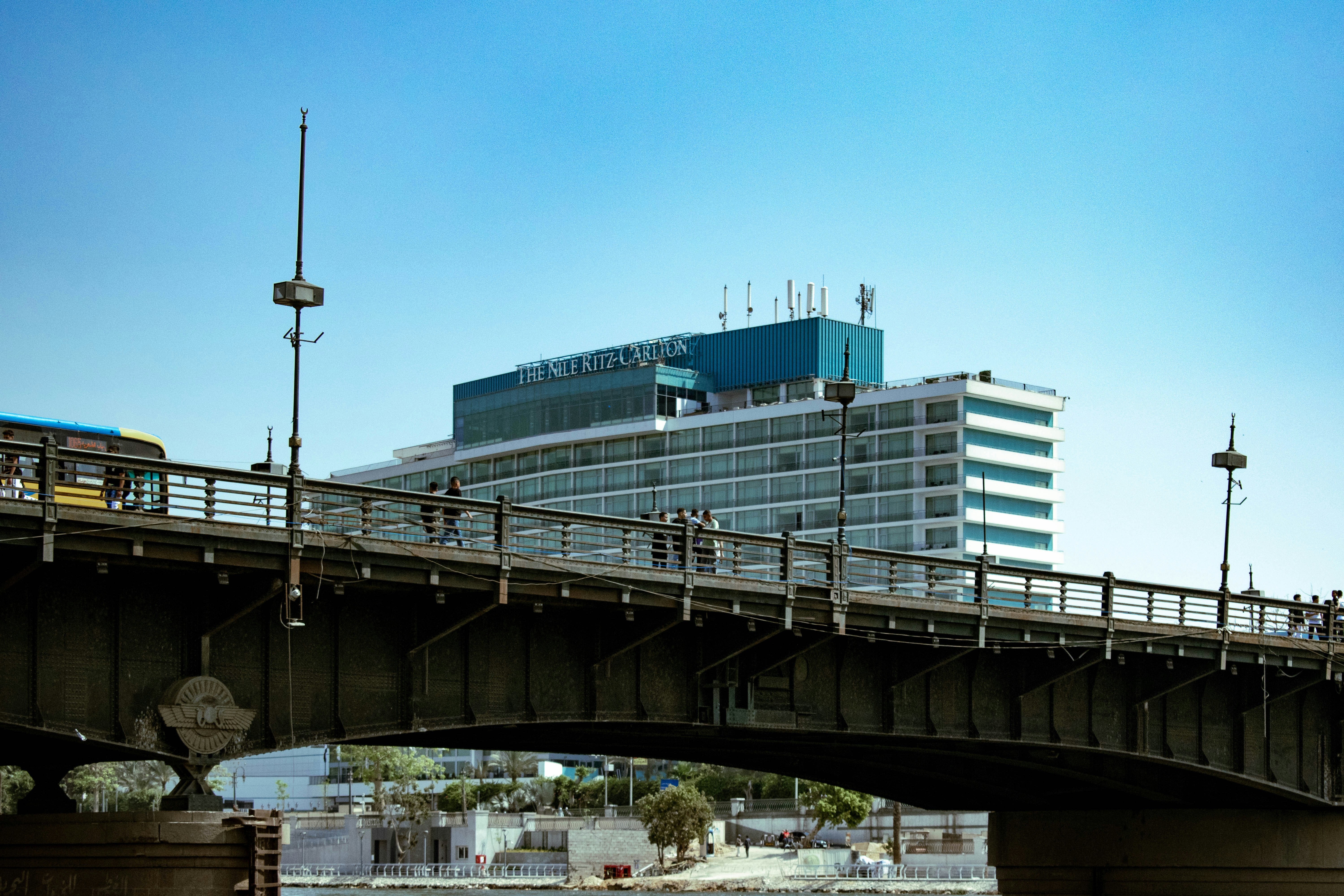 A bridge over a body of water with a building in the background