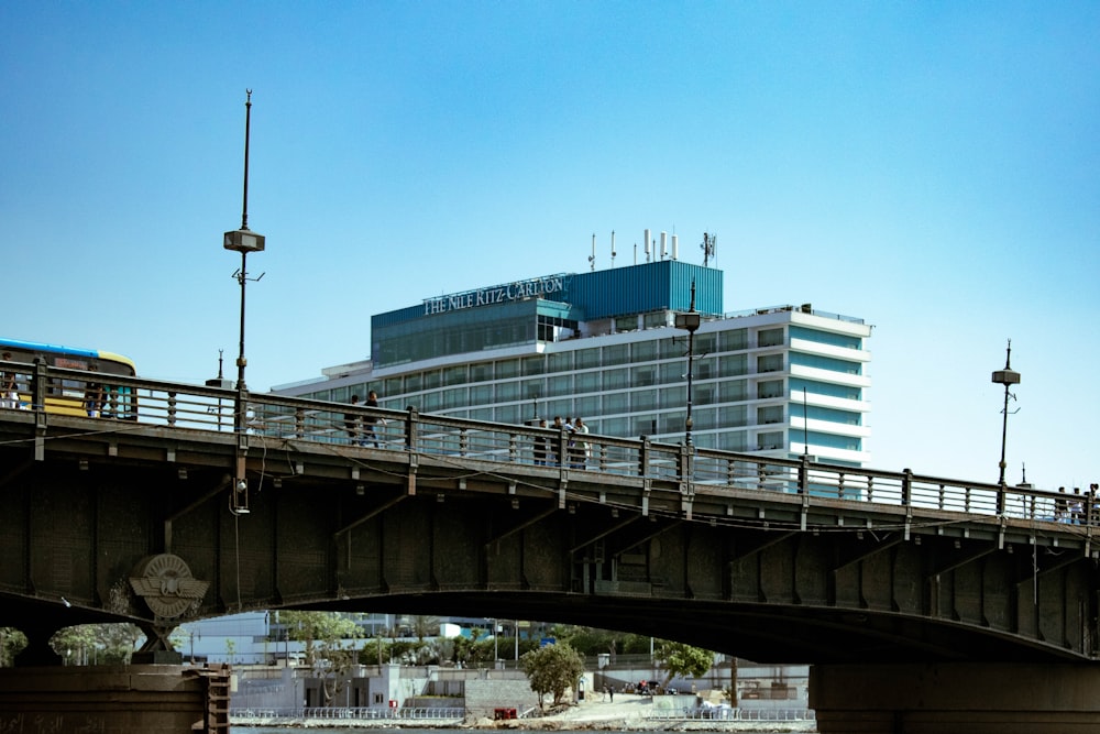 a bridge over a body of water with a building in the background