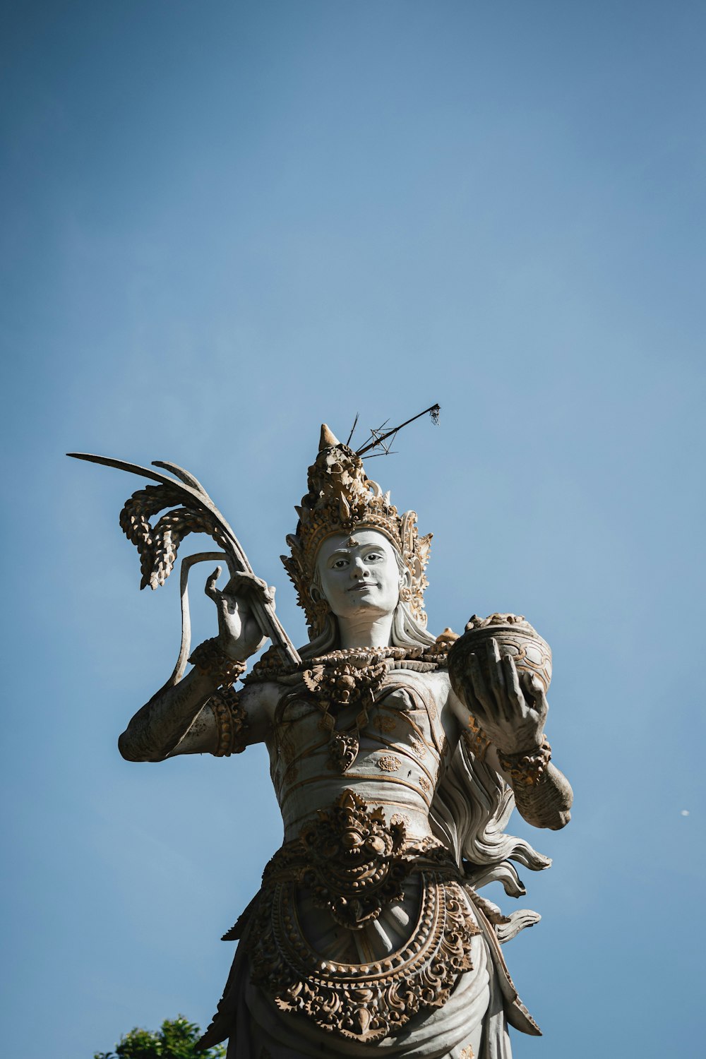 a statue of a woman holding a bird in her hand