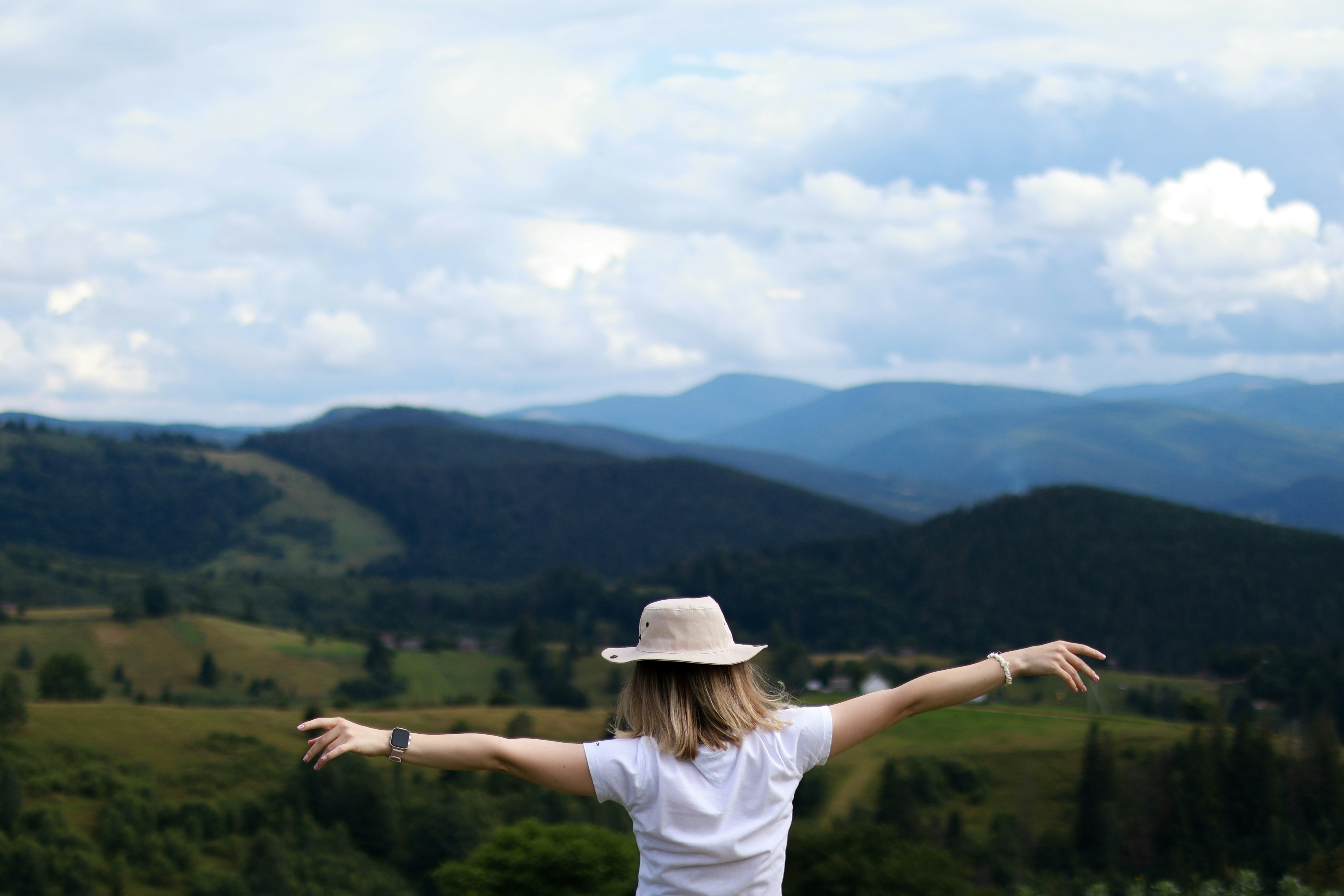 Happy woman high in the mountains