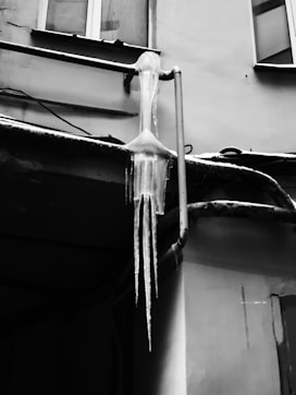 icicles hang from the side of a building