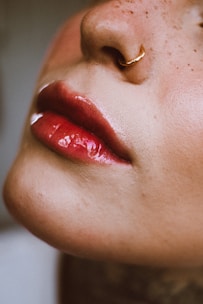 a close up of a woman's face with a nose ring