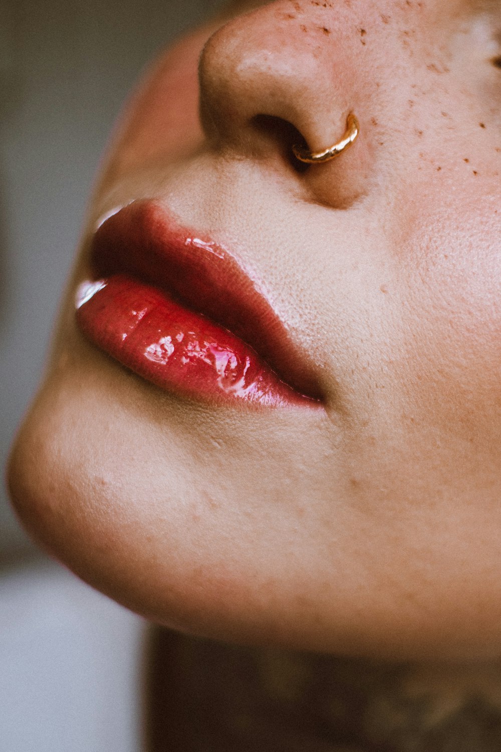a close up of a woman's face with a nose ring