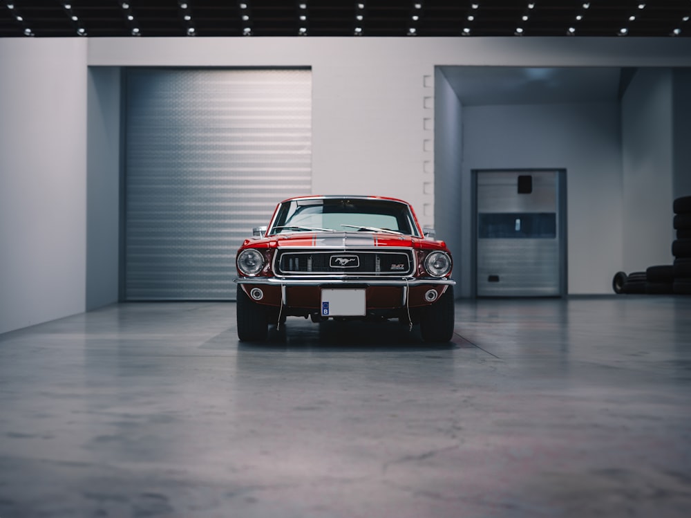 a red and black car parked in a garage