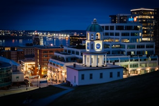 a clock tower in the middle of a city at night