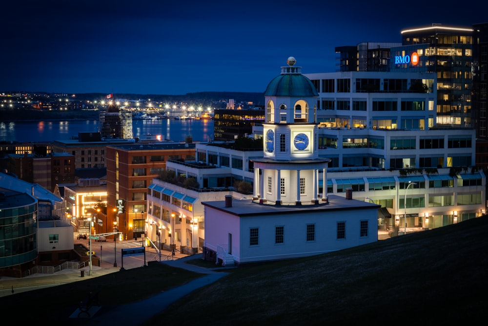 a clock tower in the middle of a city at night