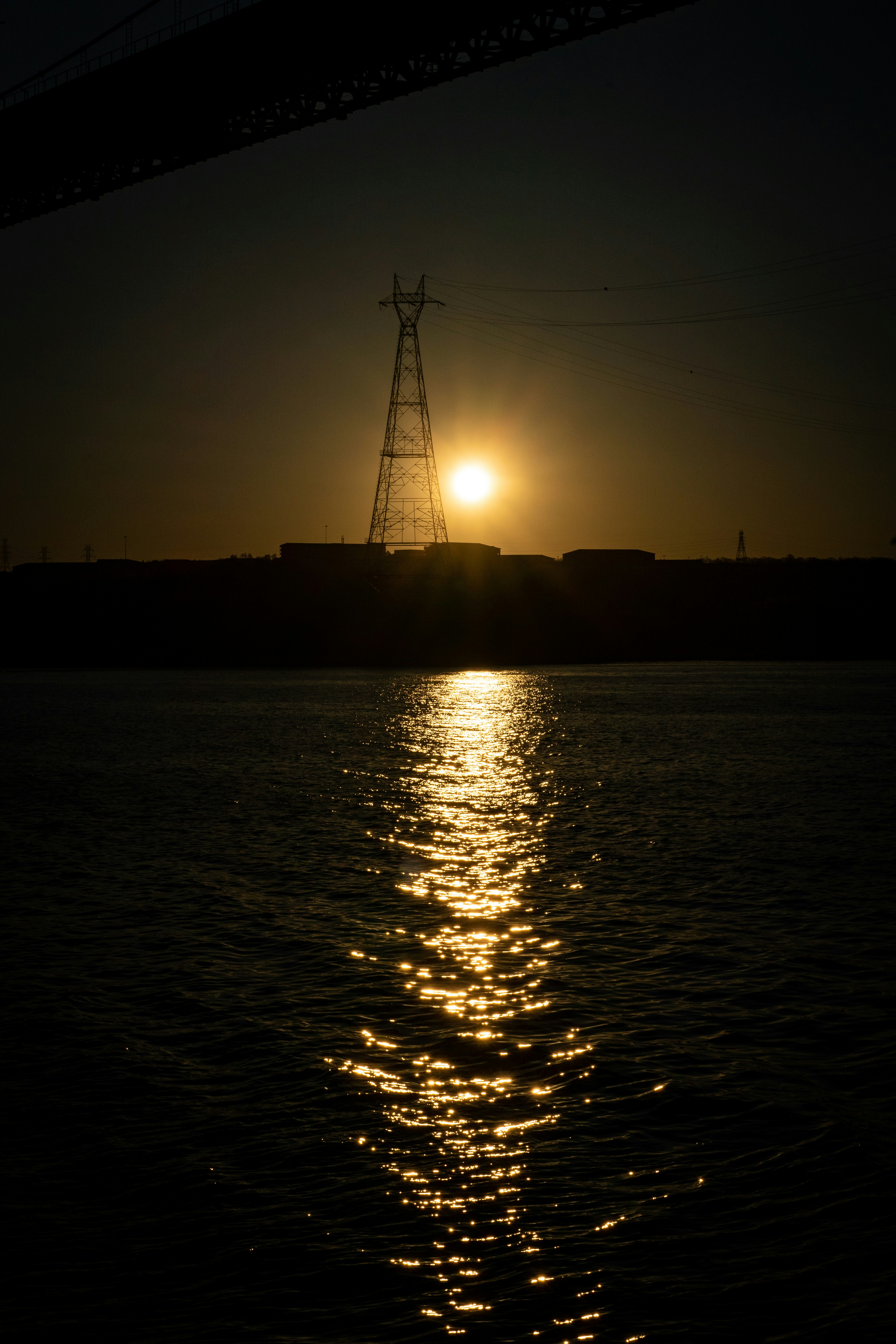 the sun is setting over a body of water