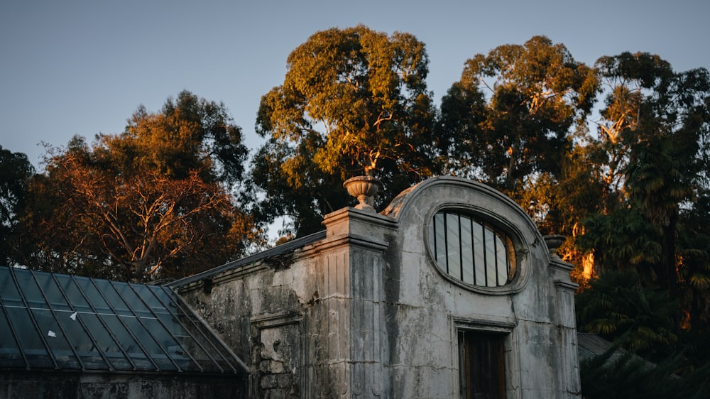 an old building with a round window and a green roof