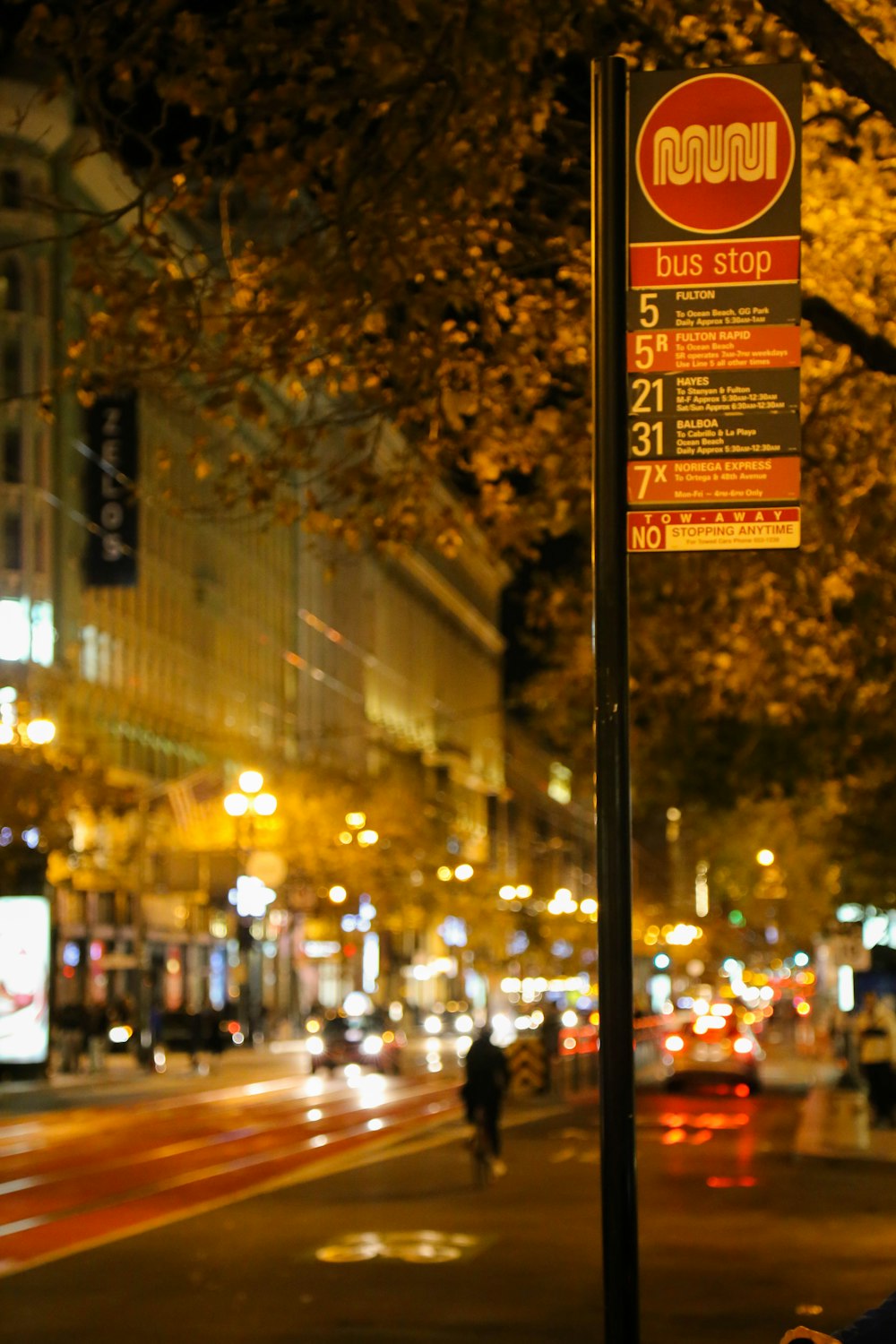a street sign on a city street at night