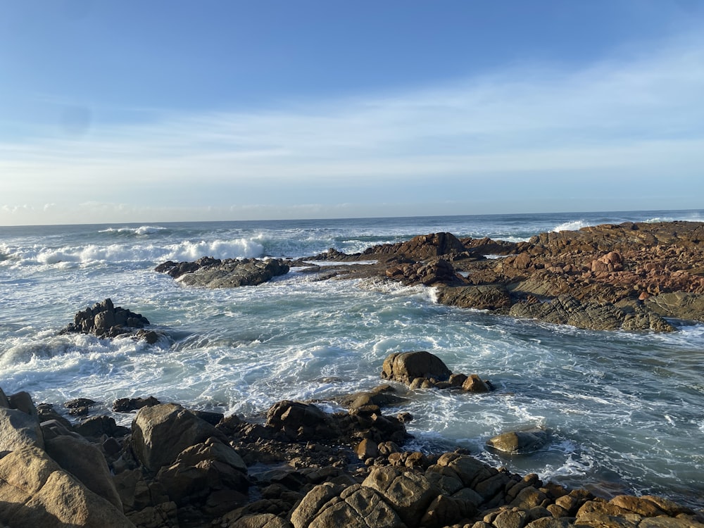 a view of the ocean from a rocky shore