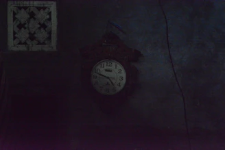 A clock showing late night hours with a wrench and plumbing tools nearby.