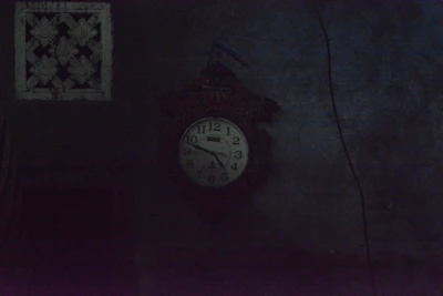 A clock showing late night hours with a wrench and plumbing tools nearby.
